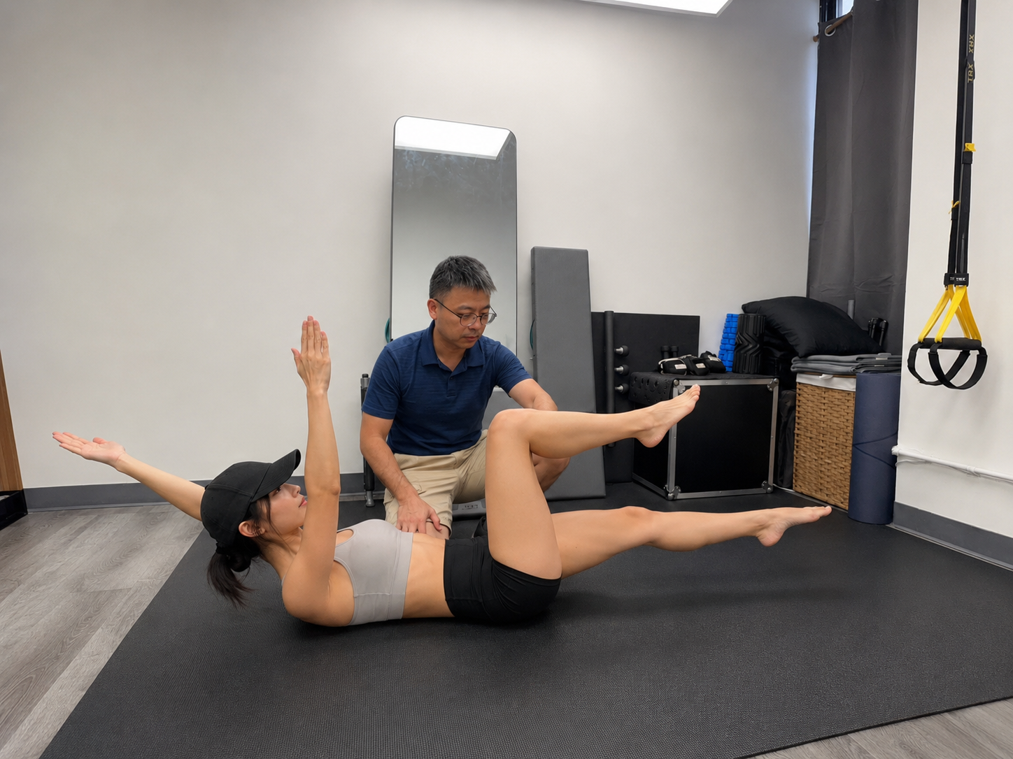 Physical therapist guiding a patient through a low back rehabilitation exercise